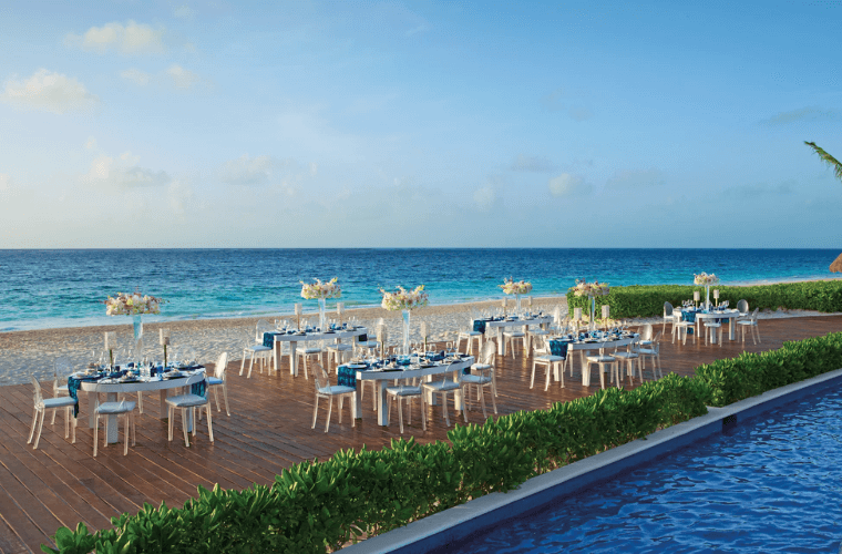 gala dinner setup at Dreams Riviera Cancun with a backdrop of the Caribbean Sea 
