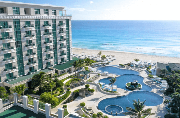 aerial view of the pool and accommodation block at Sandos Cancun with the Caribbean Sea in the background 