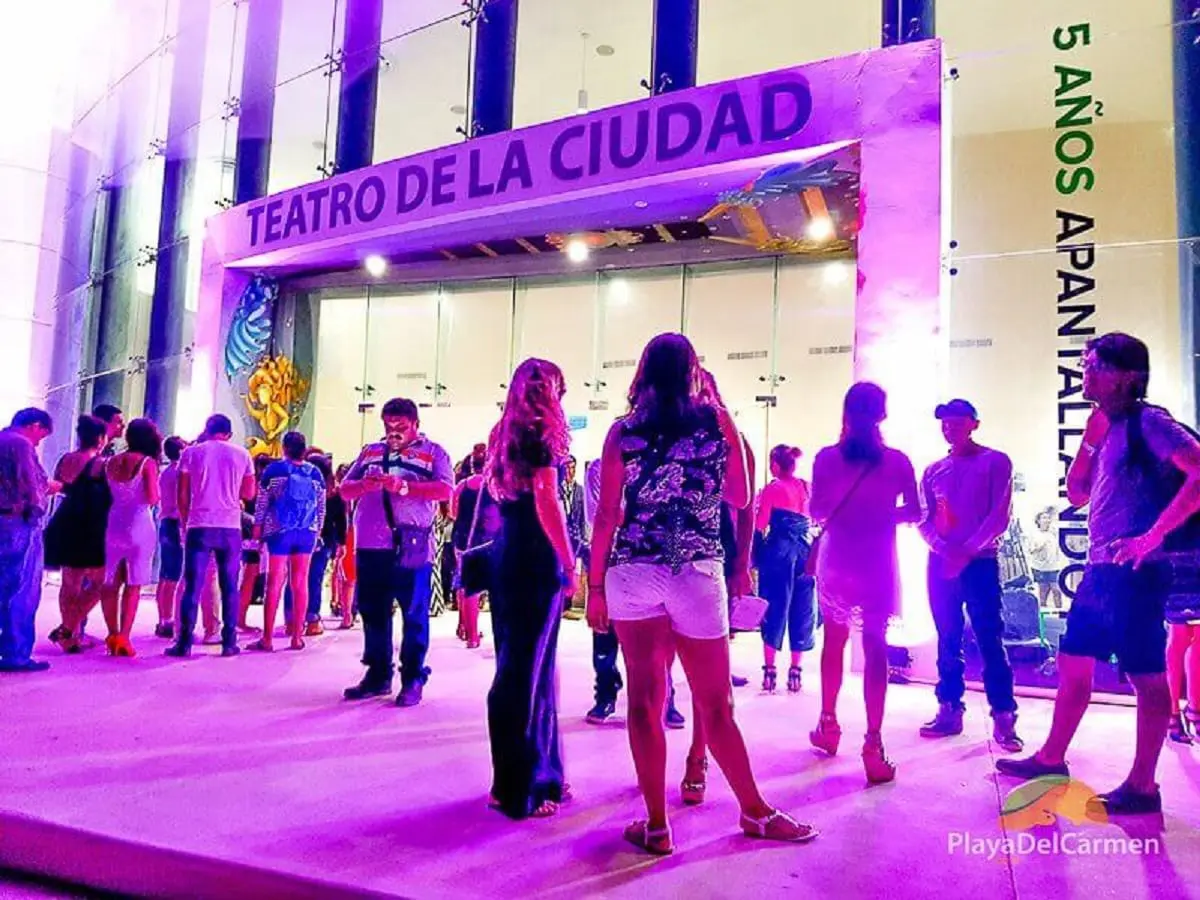 People standing in front of the city theater