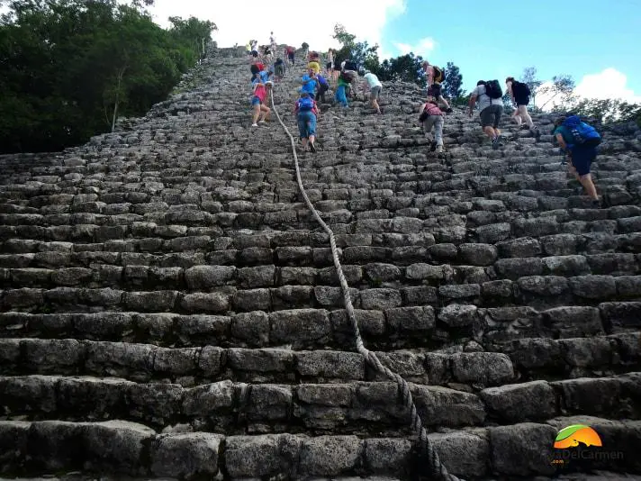 People climbing up the Coba pyramid with a rope