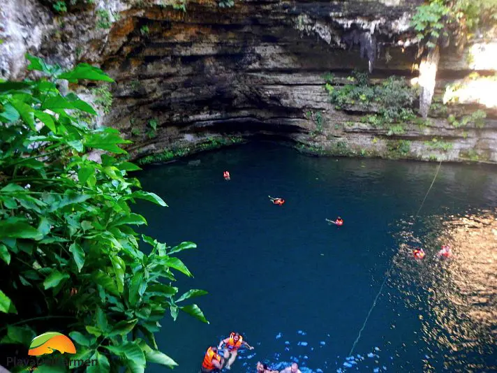Chichen Itza Cenote with people swimming