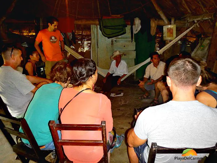 People sitting in a circle in Mayan Village 