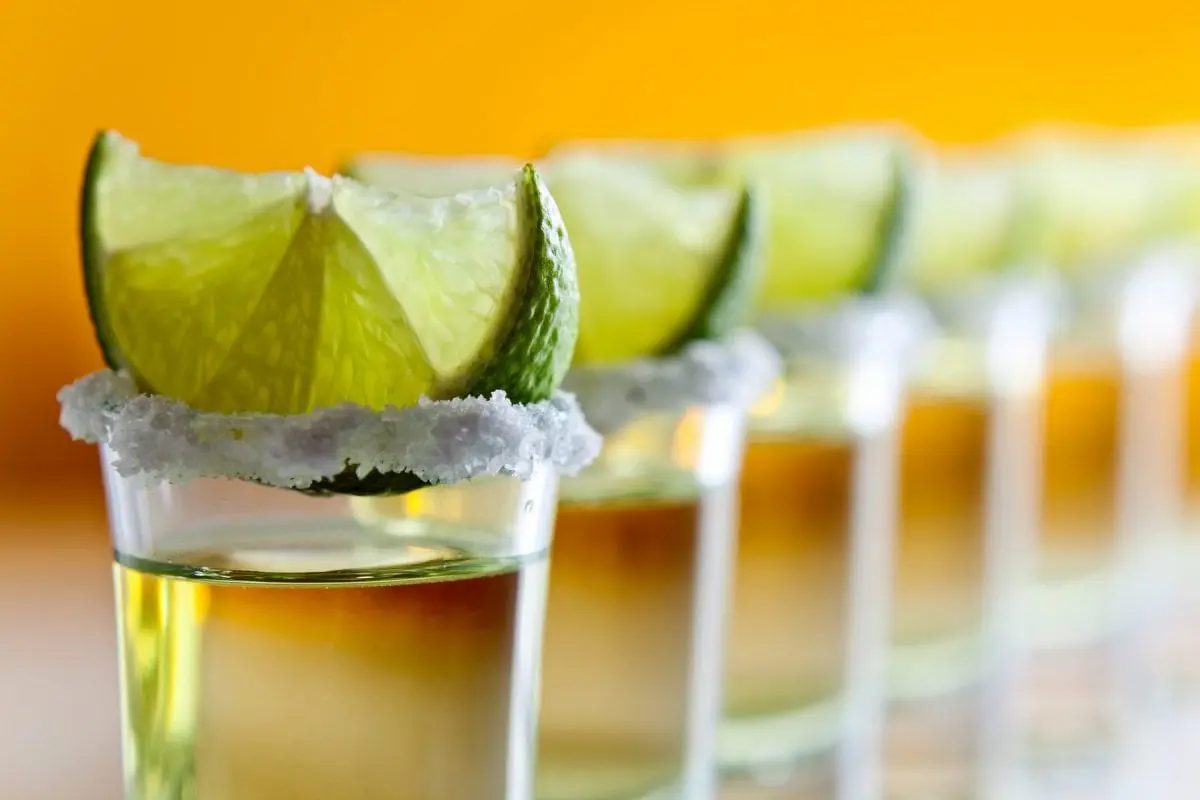 Shots of tequila with slice of lime on top