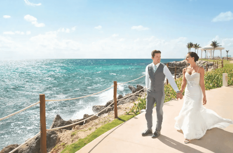 wedding couple walking by the Caribbean Sea 