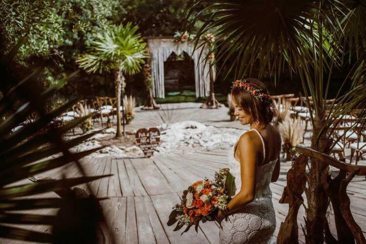 a bride holding a bouquet at the cenote wedding venue Sandos Caracol