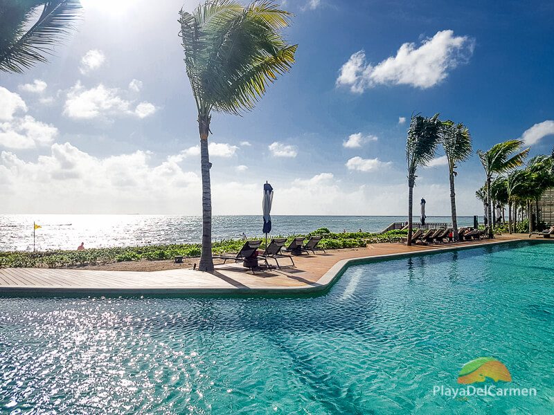 Andaz Mayakoba swimming pool by the beach on sunny day