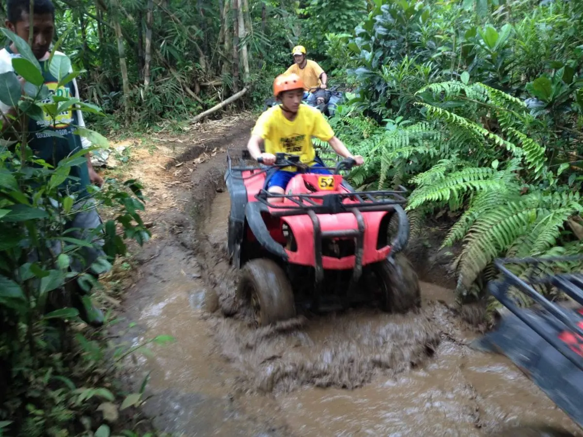 Riding atv in mud in the jungle