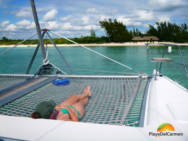 Person tanning on catamaran tour in playa del carmen