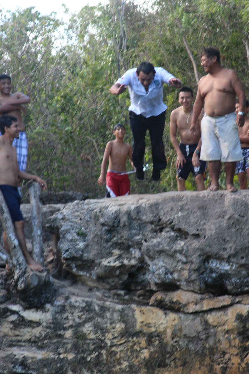 People jumping in the cenote azul 