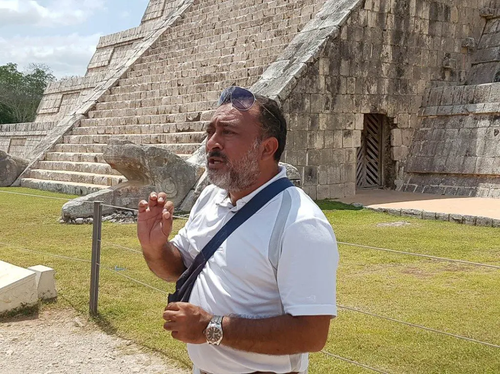 A tour guide explains the history of the Mayan people on a Chichen Itza tour