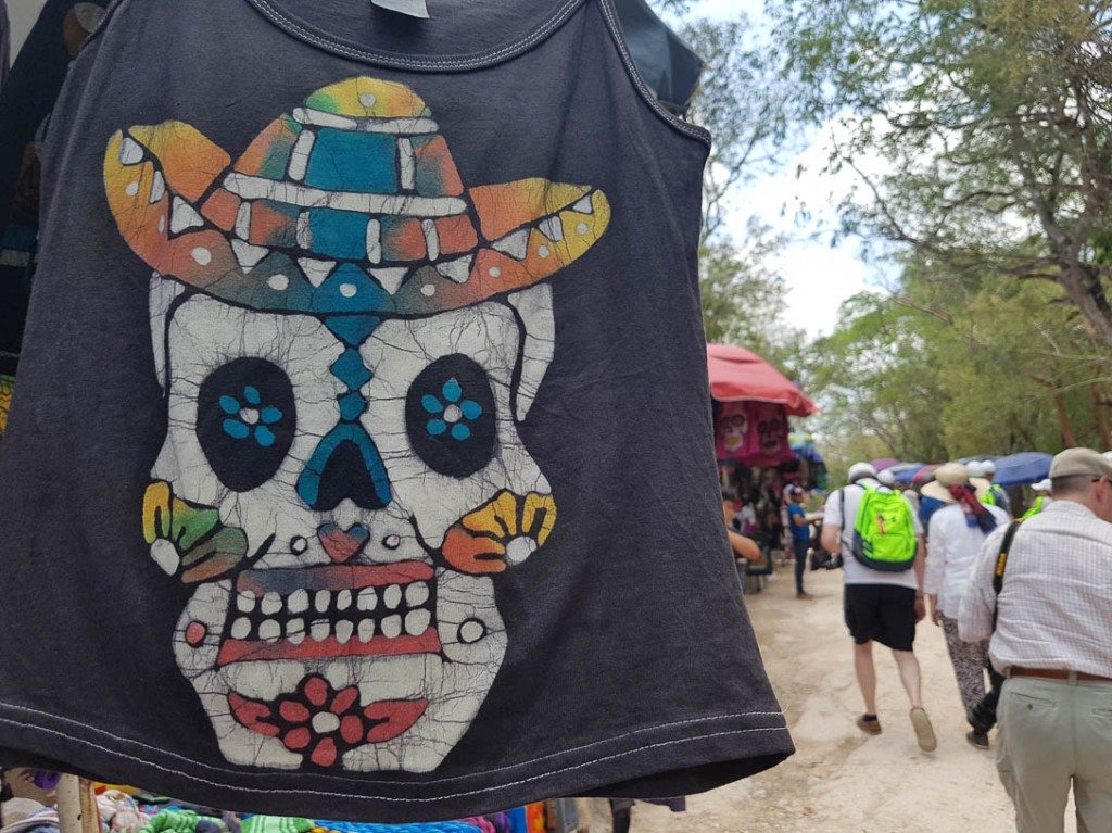 Tourists walking past vendors on a Chichen Itza tour