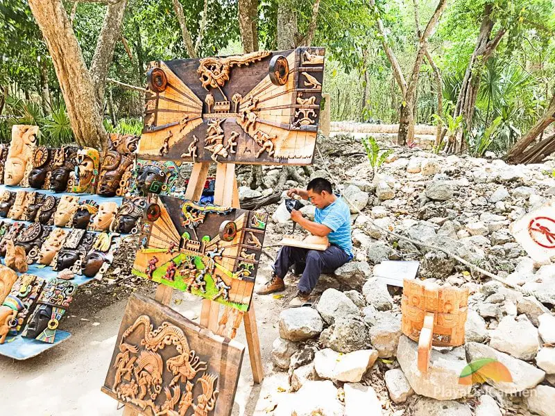 Local artist at Chichen Itza sculpting wooden Mayan figures