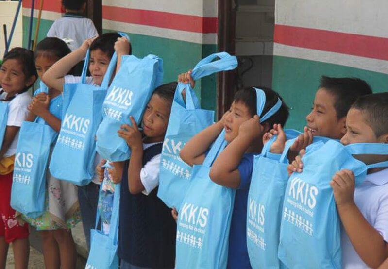 Kids with blue bags at the Keeping Kids in School Project in Playa del Carmen