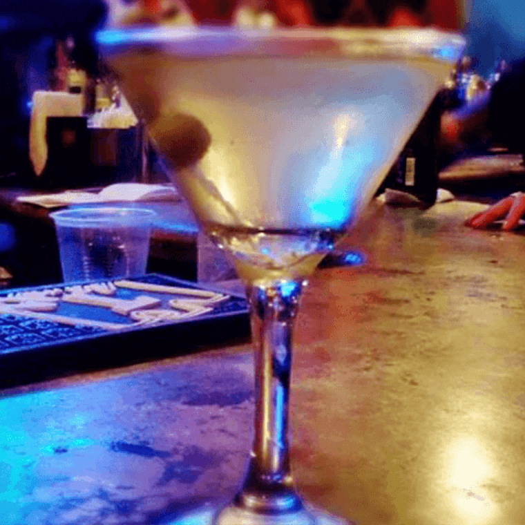 a cocktail glass with a drink in it