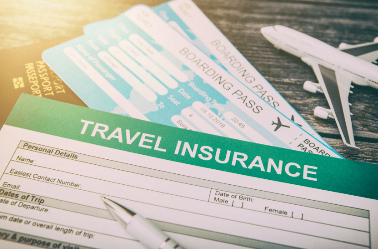 a travel insurance form with two boarding passes and a pen
