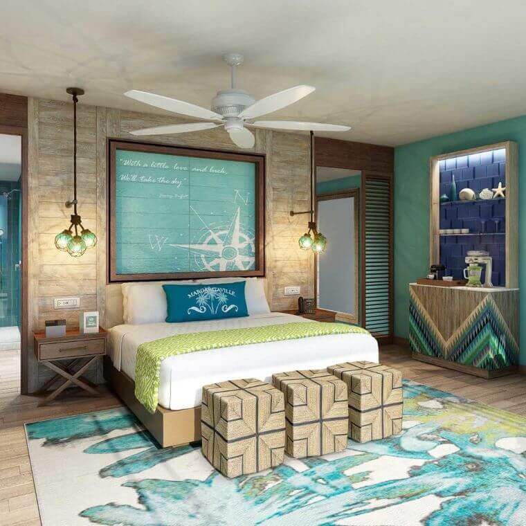 a room with a double bed and ceiling fan decorated in blue and green