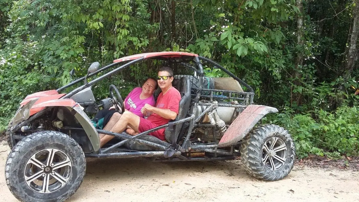 People in dune buggy in the jungle