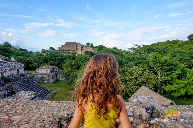 Girl looking at Mayan pramid in Ek Balam