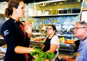 Talented Chef Karla Enciso teaching people about cooking at El Pueblito Cooking School at Mayakoba