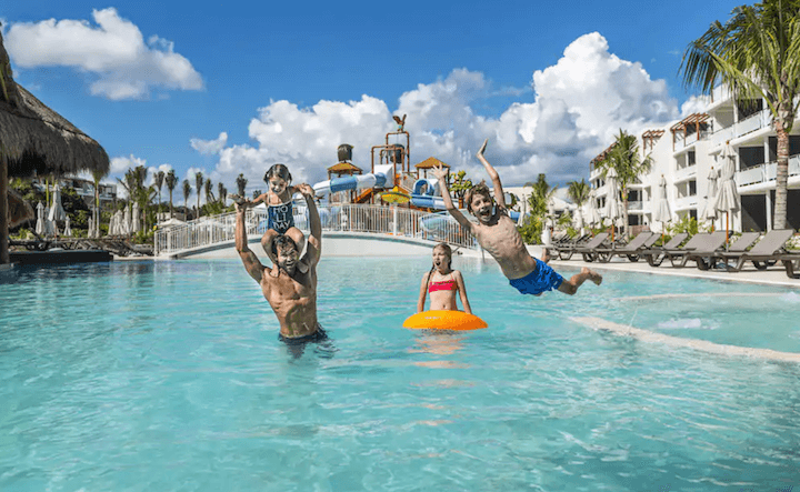 kids and dad playing in the pool