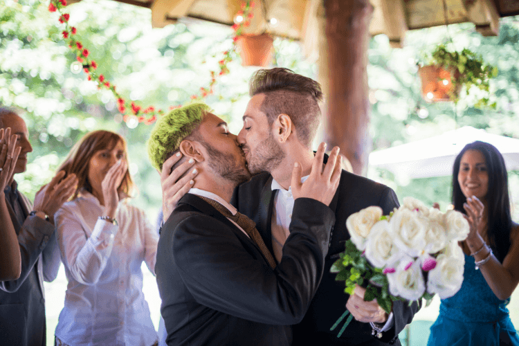 an all-male couple kissing on their wedding day 
