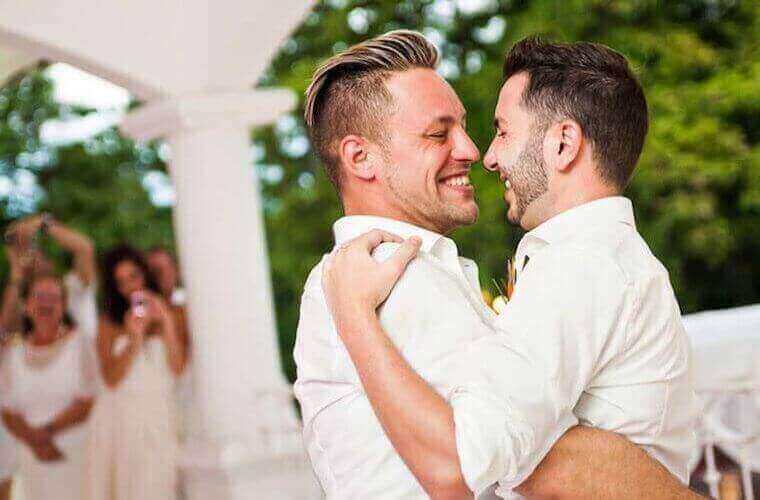 An all-male wedding couple dancing 