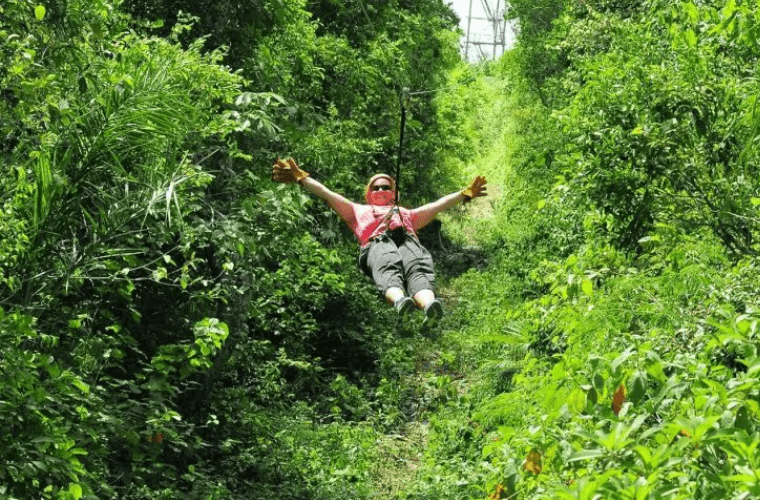 a woman ziplining at Tulum Xtreme 