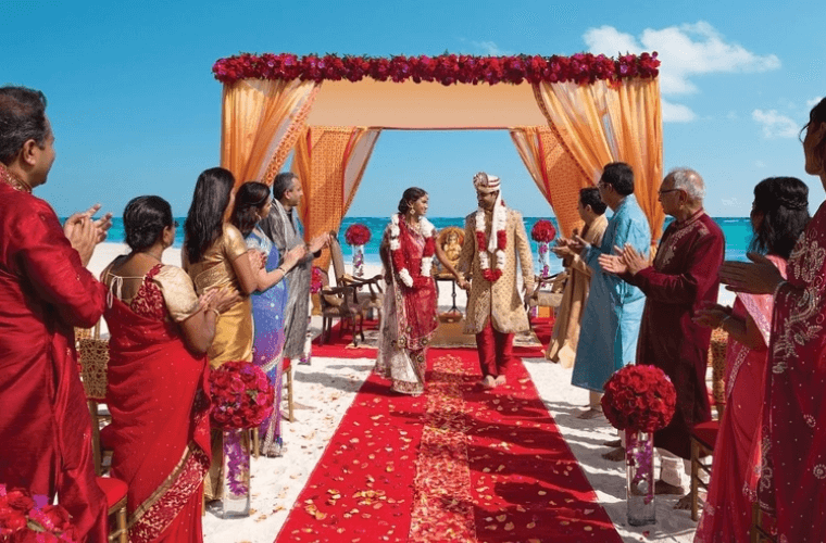 a couples walking down the aisle at their Indian wedding 