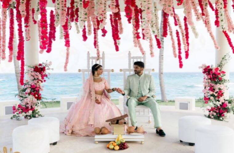 an Indian wedding couple with the Caribbean Sea in the background 