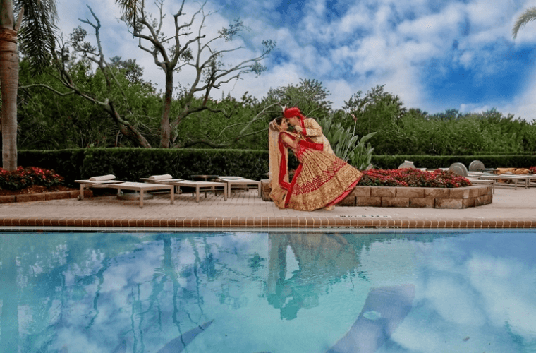 an Indian couple by the side of a swimming pool 