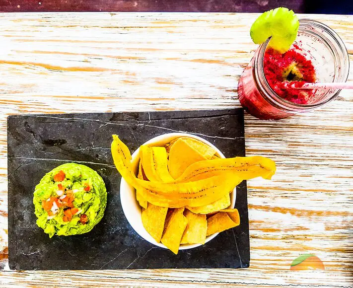 fresh-made guacamole served with tortilla chips and fried plantains at inti beach club 