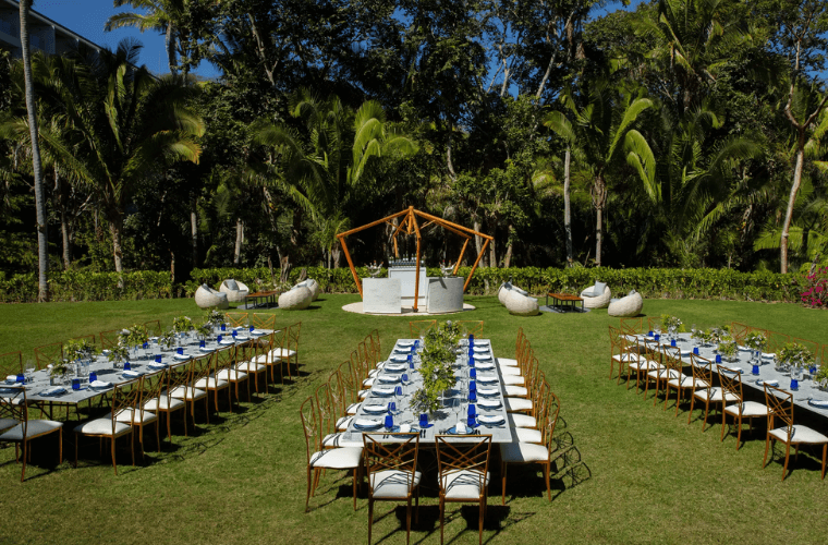 long banqueting tables set for a wedding in the garden at Bahia Mita 