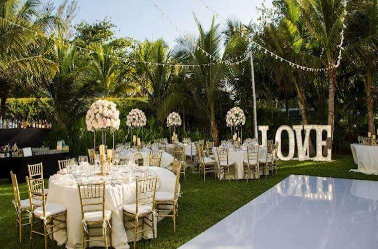 the garden wedding venue at Fives Beach with a white theme and tables set 