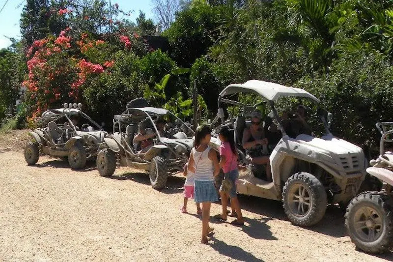 A family gets ready to ride a jungle buggy through the Riviera Maya jungle