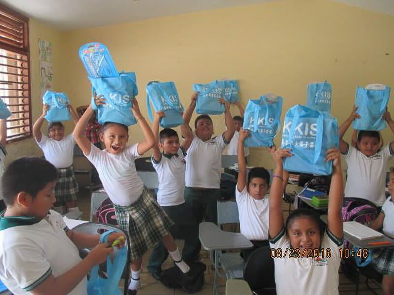 Happy kids with KKIS blue bags