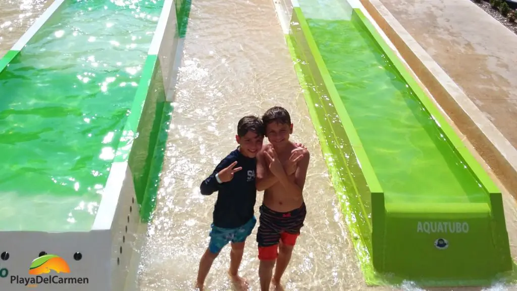 happy kids on the waterslides at sandos caracol