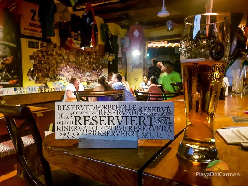 Manne's Biergarten reservation sign on table with beer