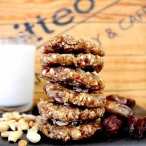 Peanut butter cookies stacked up on plate at the pitted date