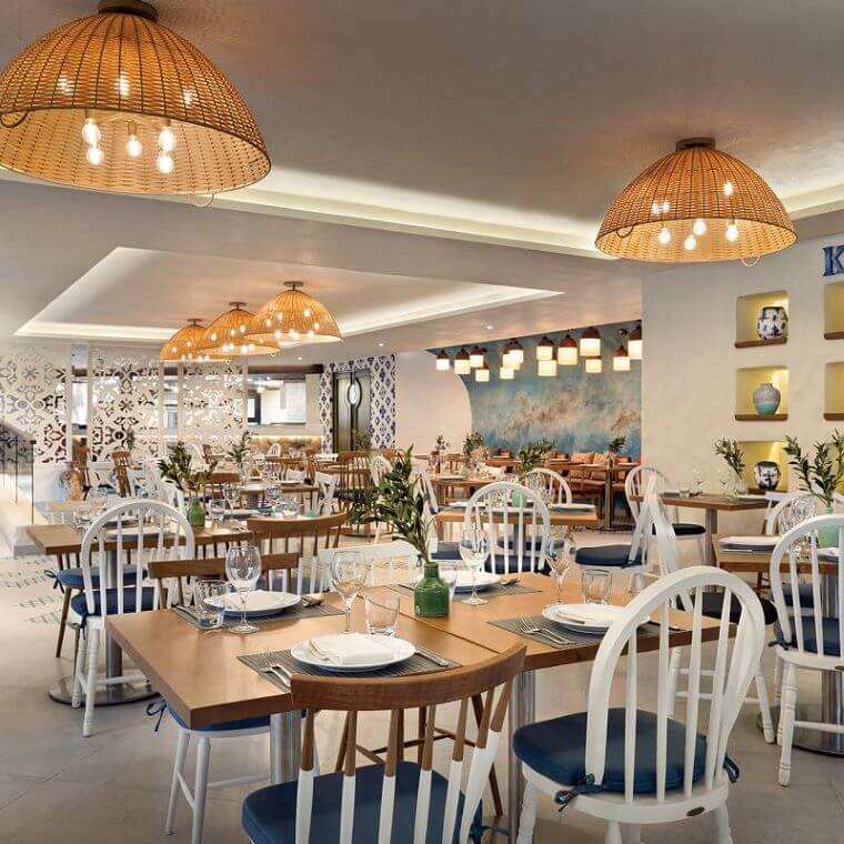 restaurant interior at Hilton Playa Del Carmen set with chairs and tables 