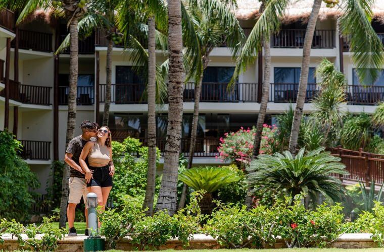 a young couple standing in front of the accommodation at The Reef Coco Beach 