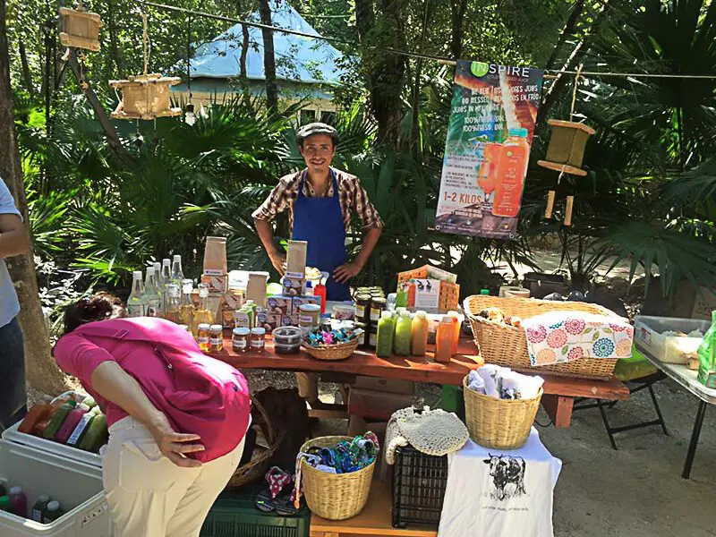 Vendor sells wares at local market in La Ceiba Park, Playa del Carmen