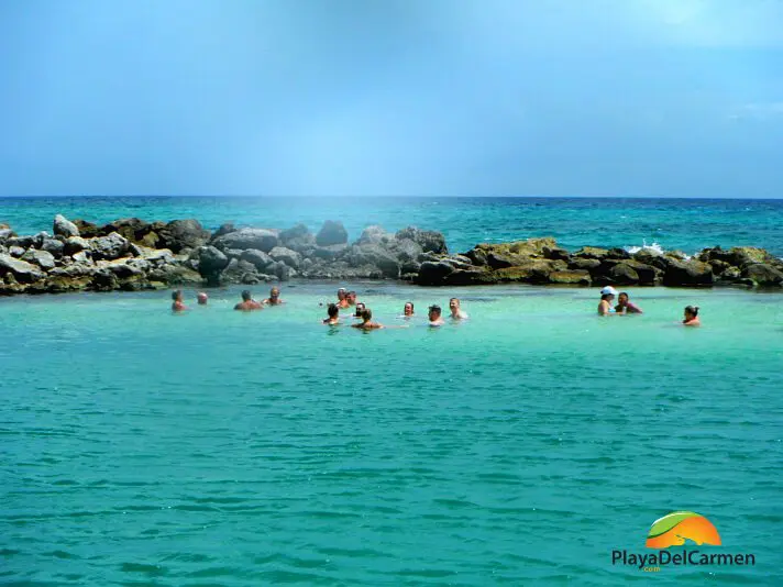 People relaxing in water in playa del carmen