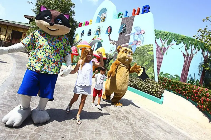 Sandos Caracol mascots walking with kids at the Playa del Carmen resort