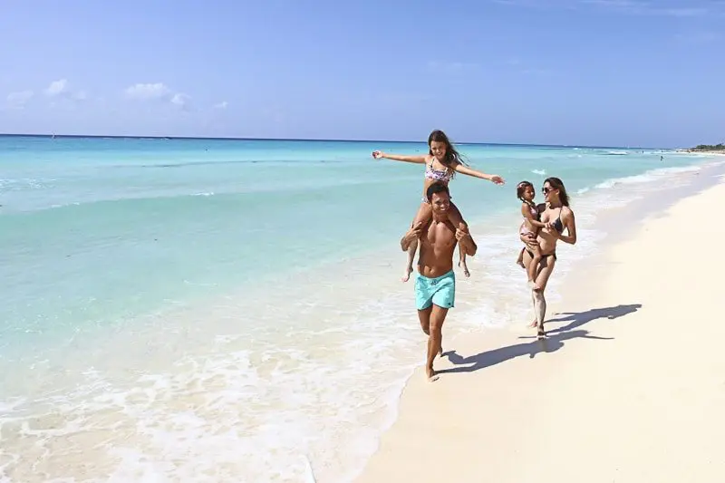 Family walking on the beach at Sandos Playacar Playa del Carmen