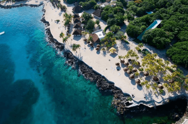 cabanas and palm trees on the beach at Cozumel 