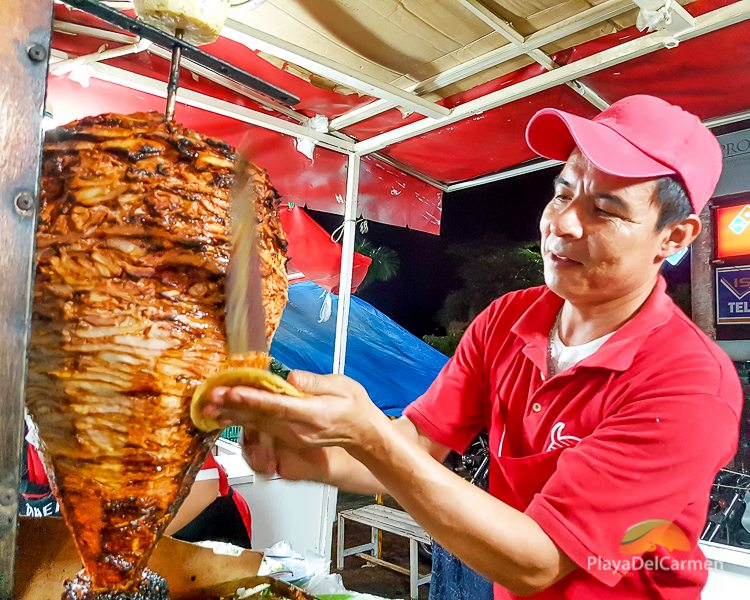 Guy cutting slow cooked meat for taco