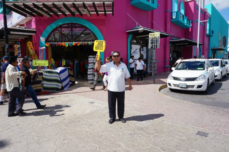 Taxi driver holds up sign in Playa del Carmen