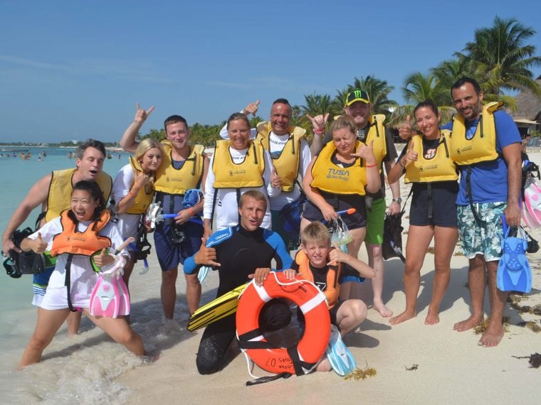 People with life jackets on the beach