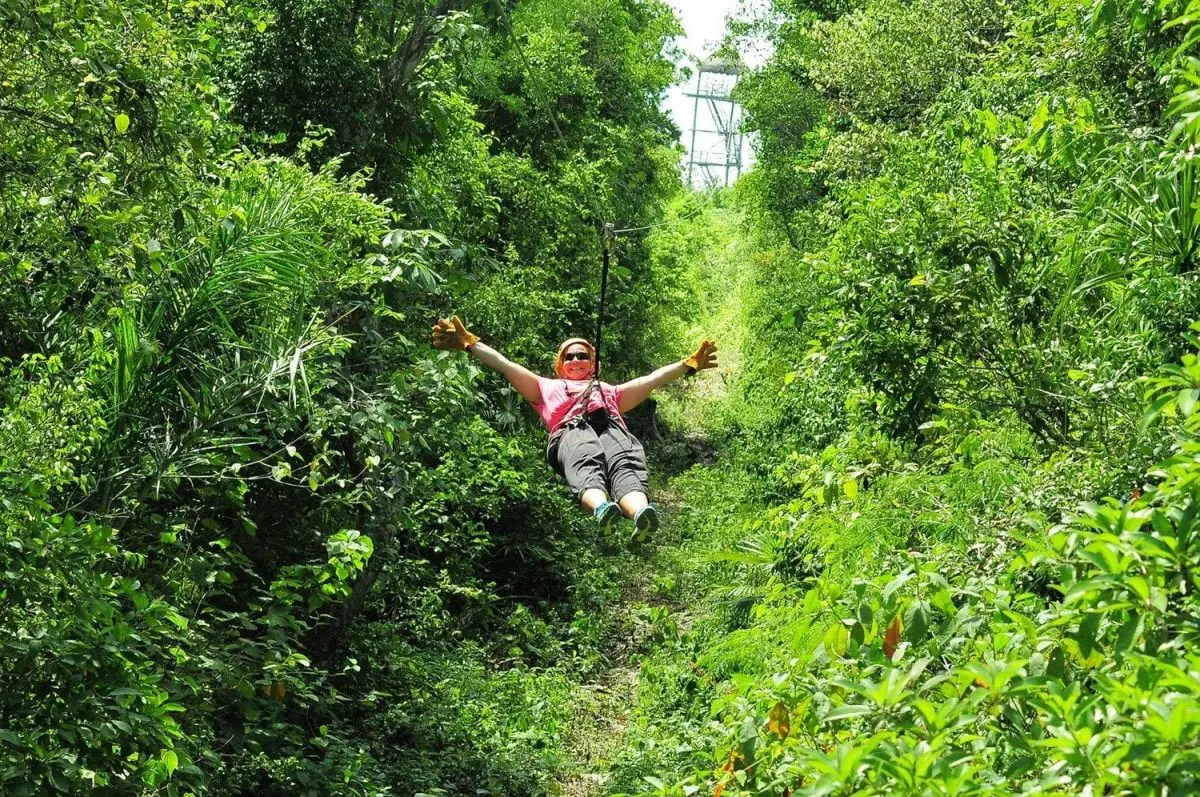 Person zip-lining tulum xtreme zipline