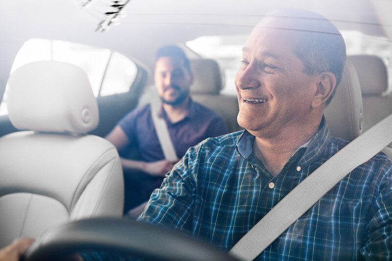 An Über driver in Mexico smiles at his passenger